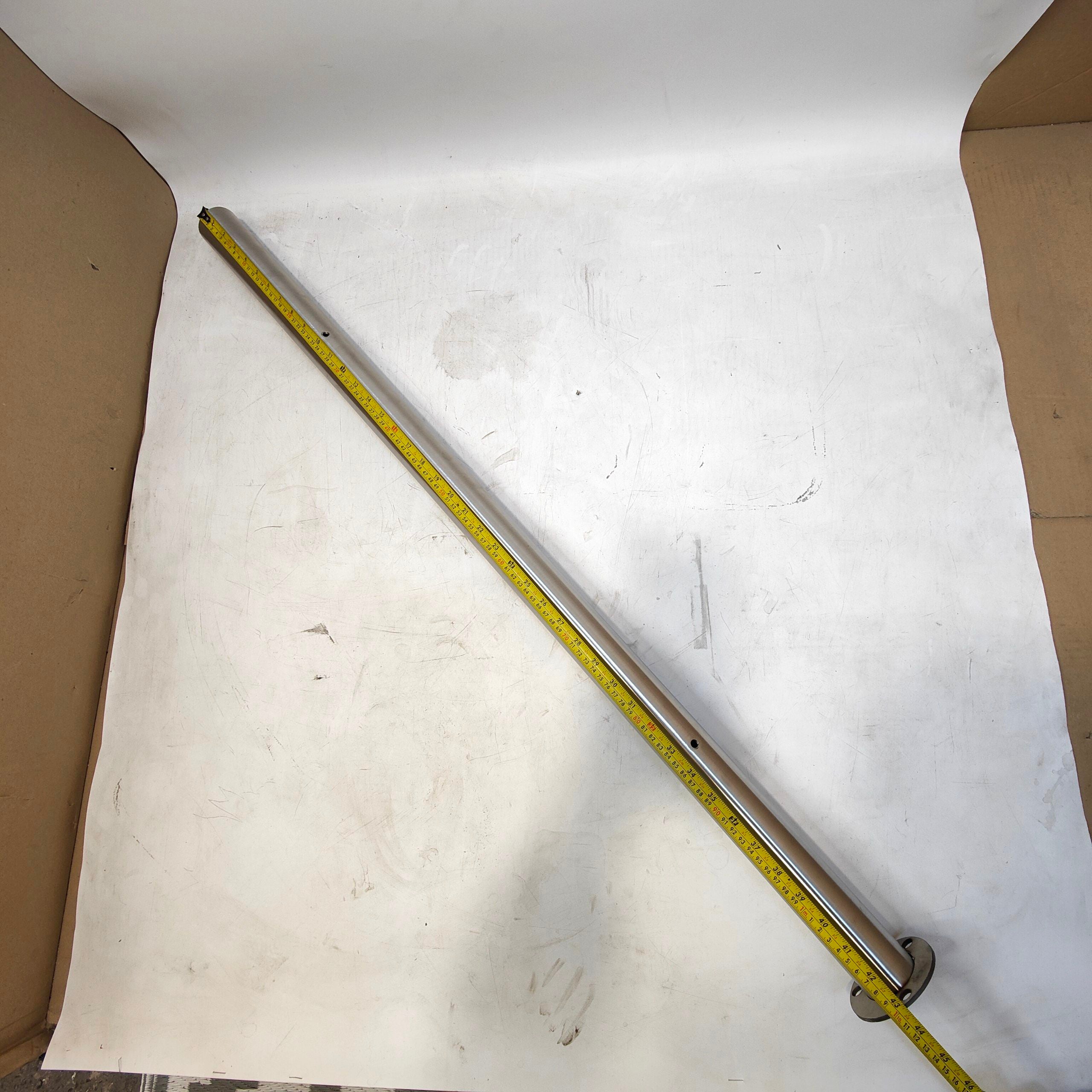 Metal rod with a tape measure on a white surface