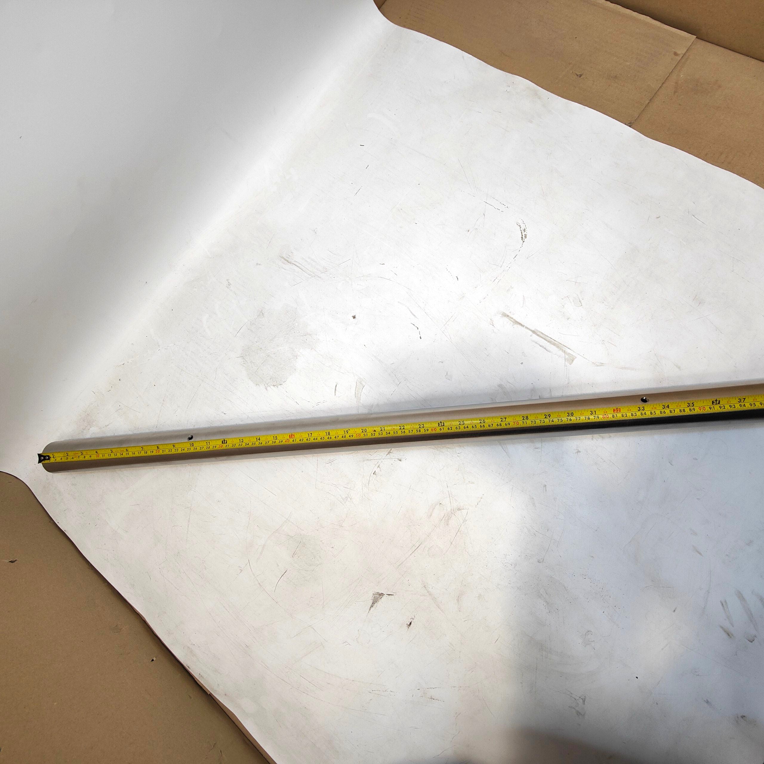 Tape measure on a white surface with cardboard edges
