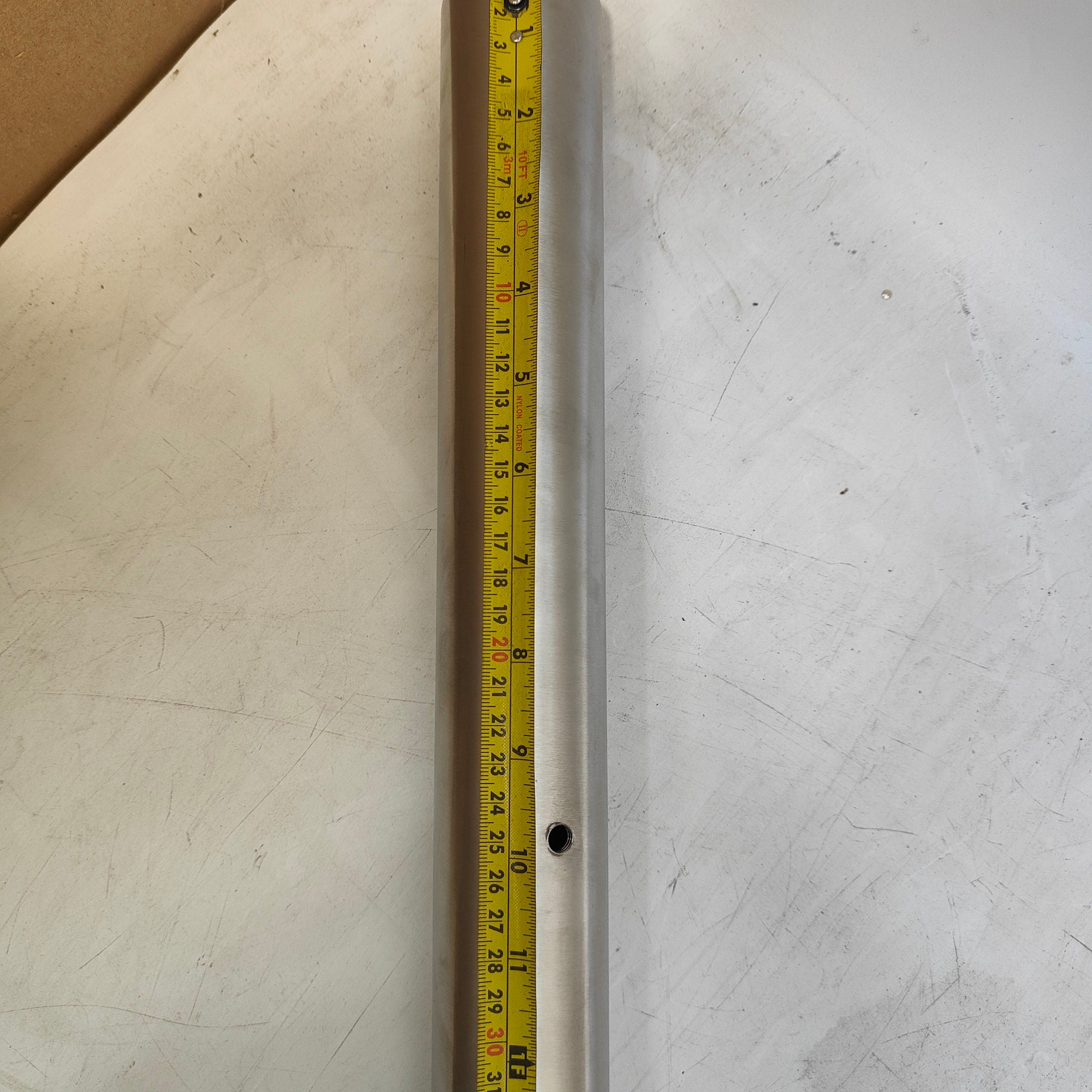 Metal rod with a tape measure on a textured surface