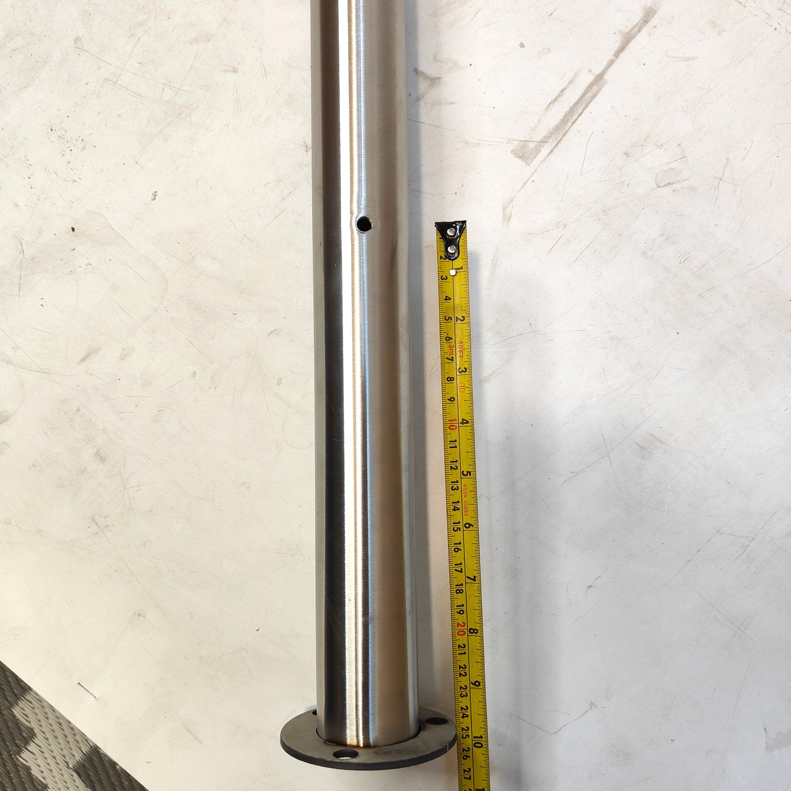 Metal cylindrical object with a tape measure for scale on a white background