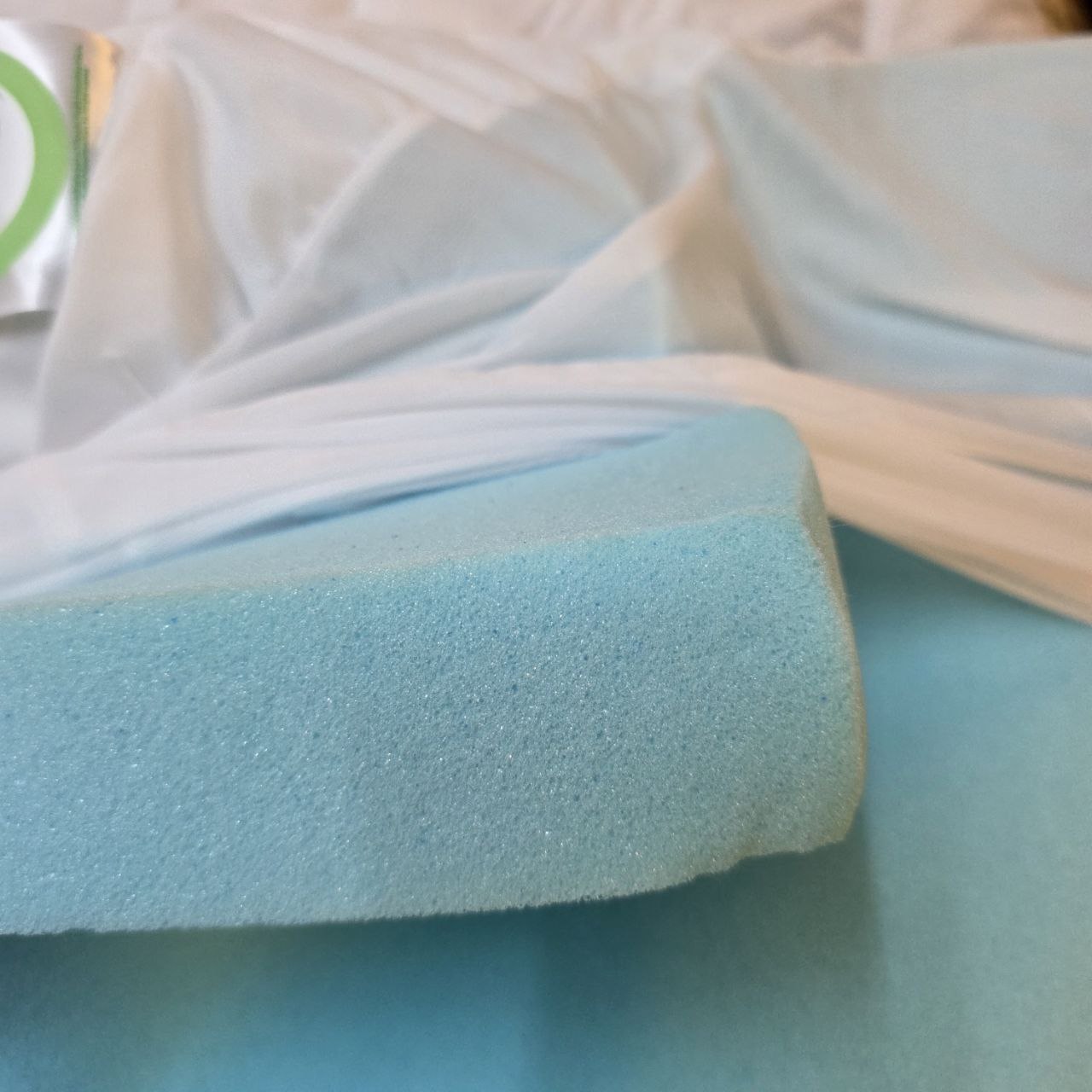 Close-up of a blue foam pad with a white border on a light background
