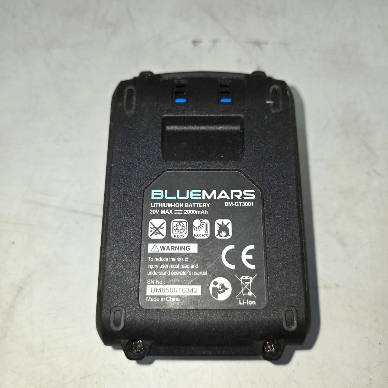 Black lithium-ion battery with 'BLUEMARS' branding on a light gray background