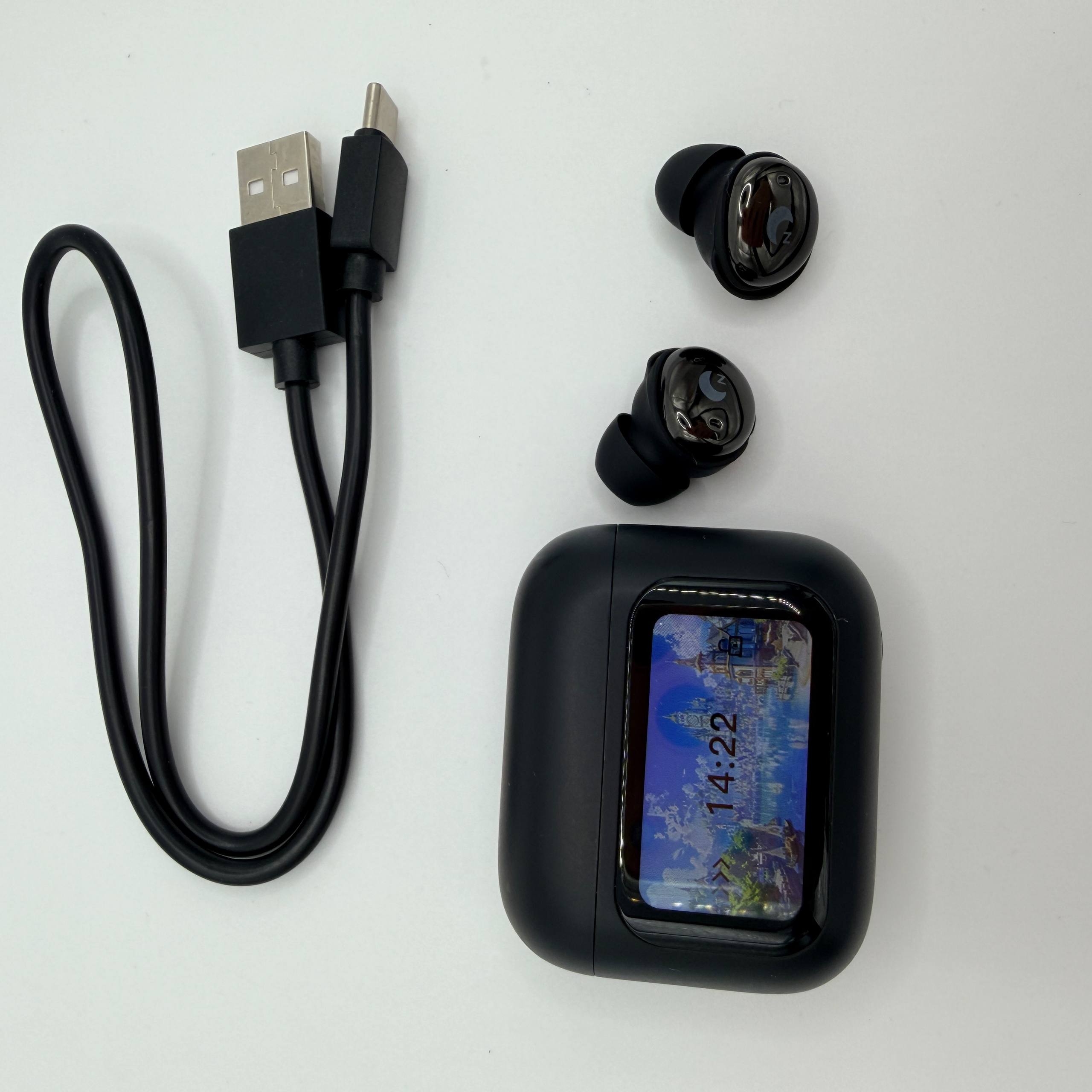 Black wireless earbuds with charging case and USB cable on a white background