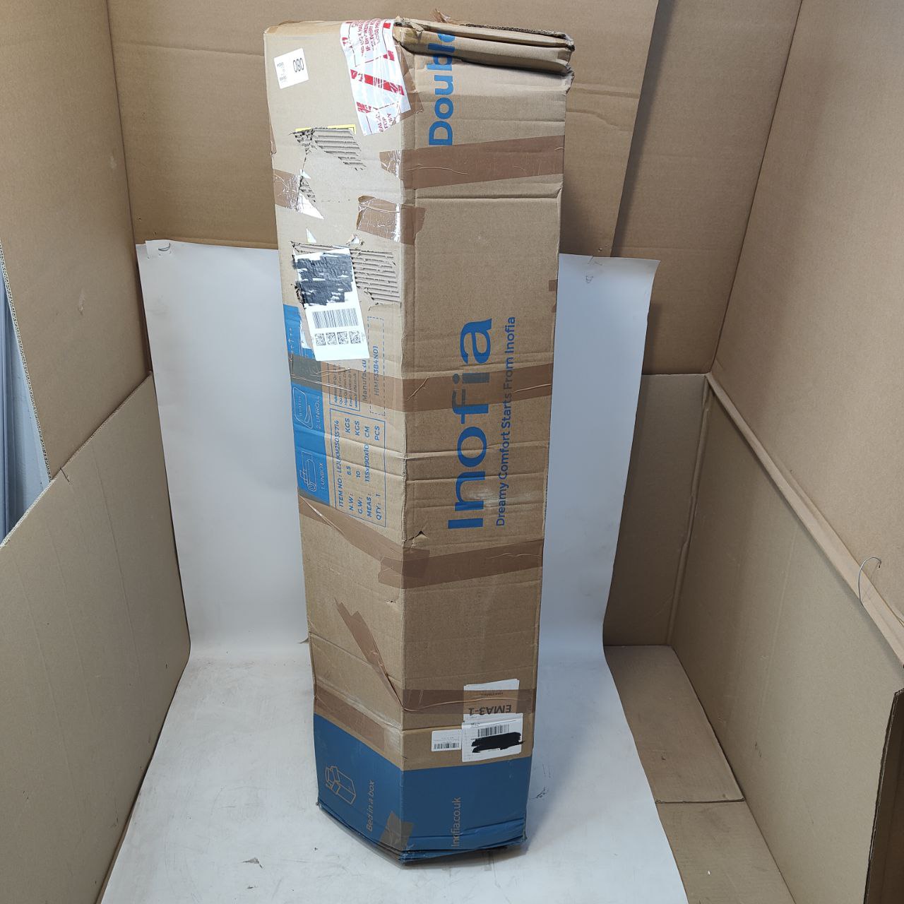 Cardboard box with 'Inofia' branding inside a larger cardboard box.