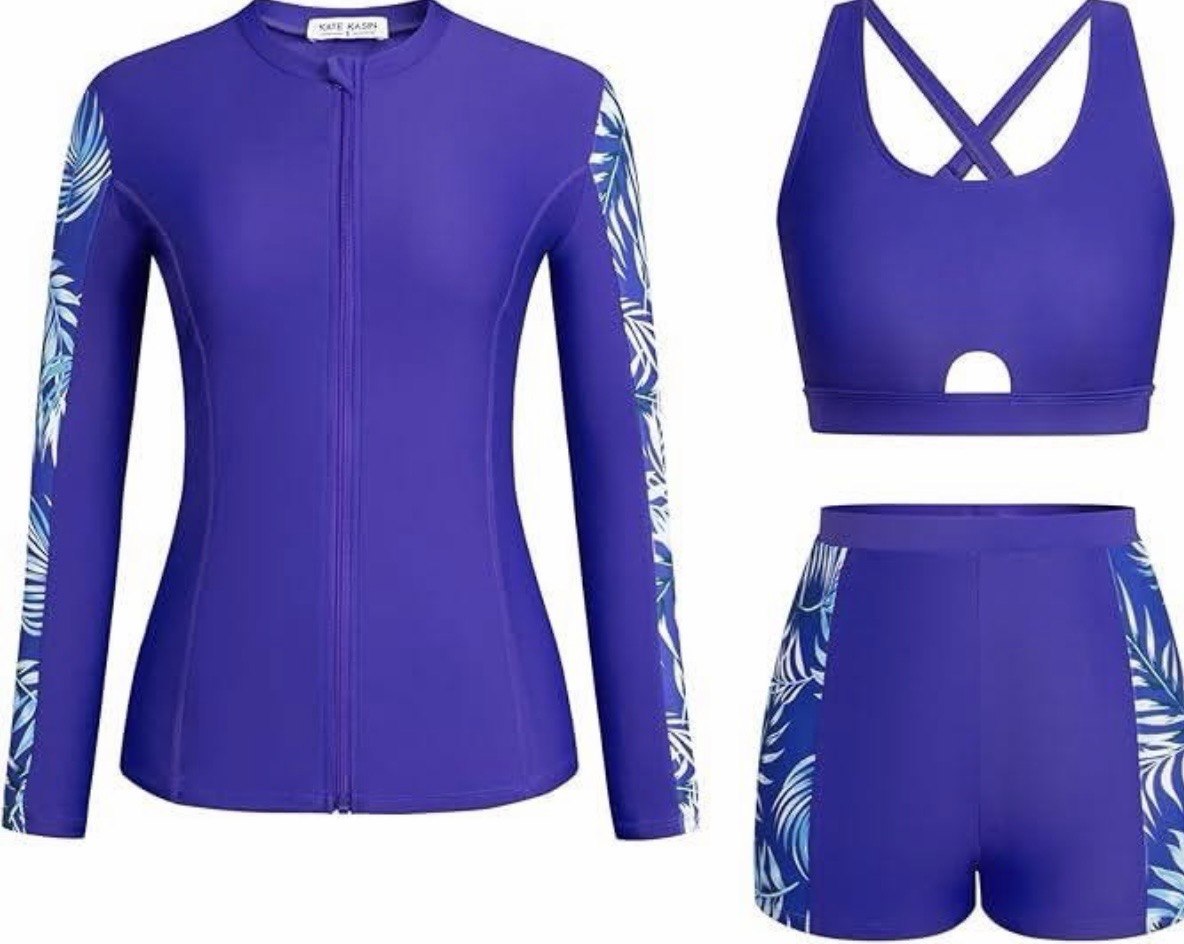 Blue athletic outfit with long-sleeve top, sports bra, and shorts on a white background