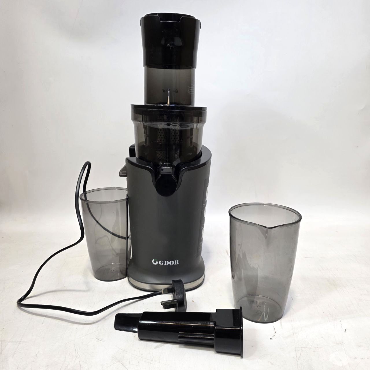 Black juicer with two clear cups on a white background