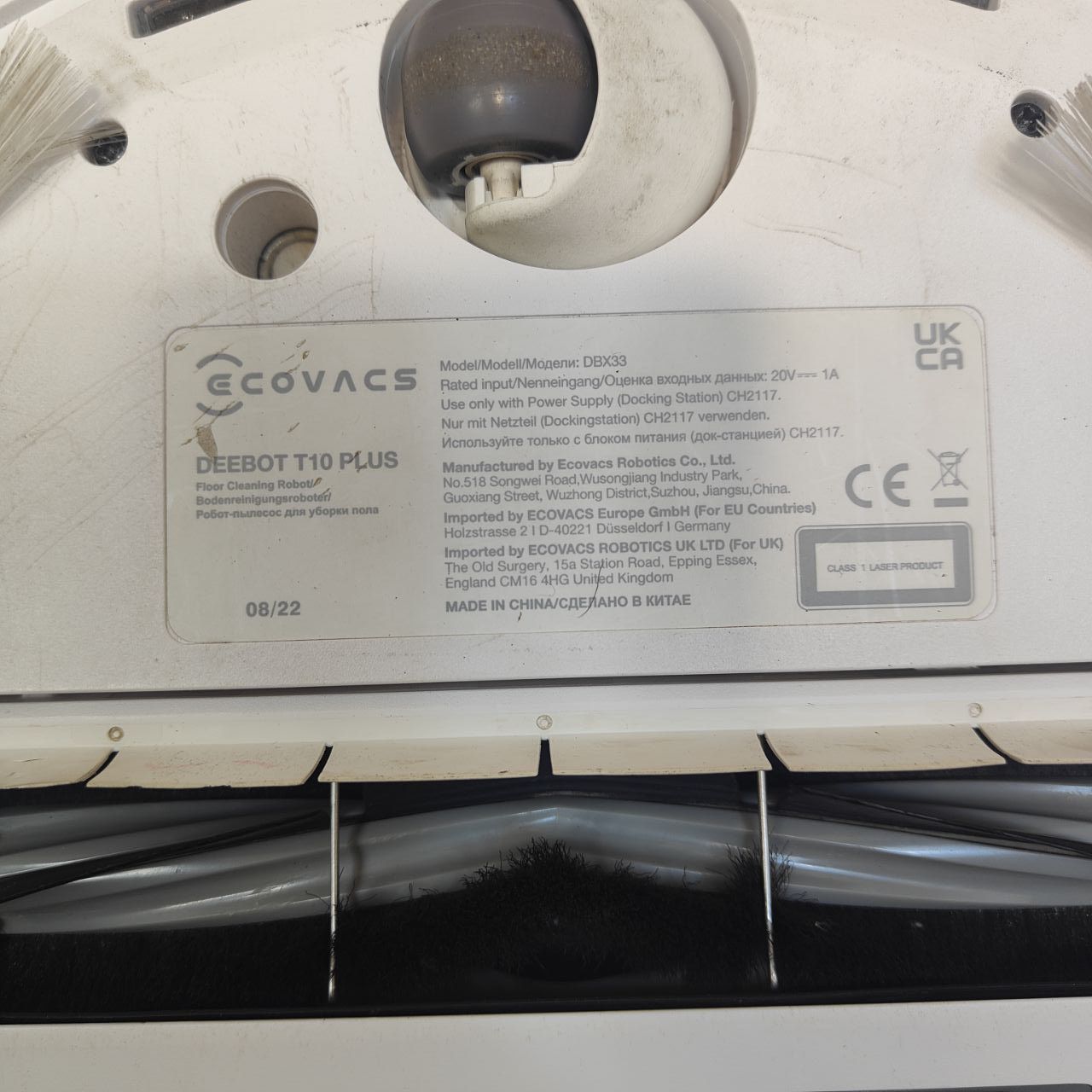 Back of a robot vacuum cleaner with 'Ecovacs' branding and model details.