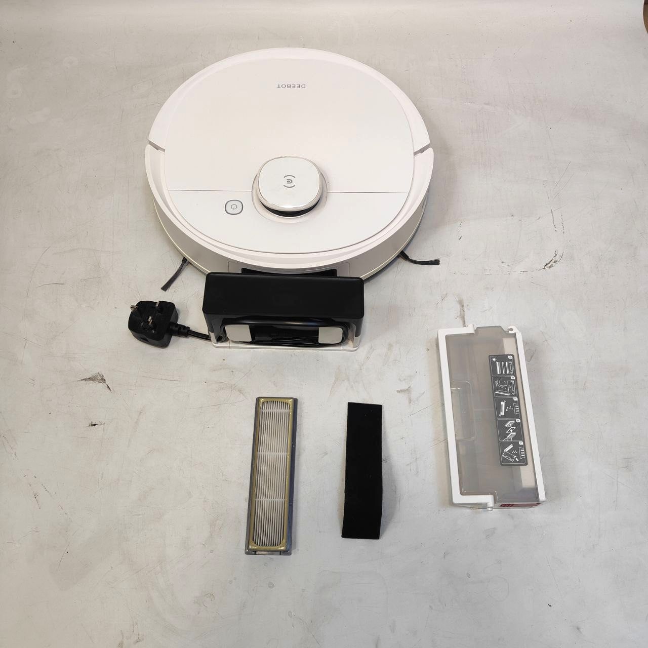Robot vacuum cleaner with attachments on a concrete floor