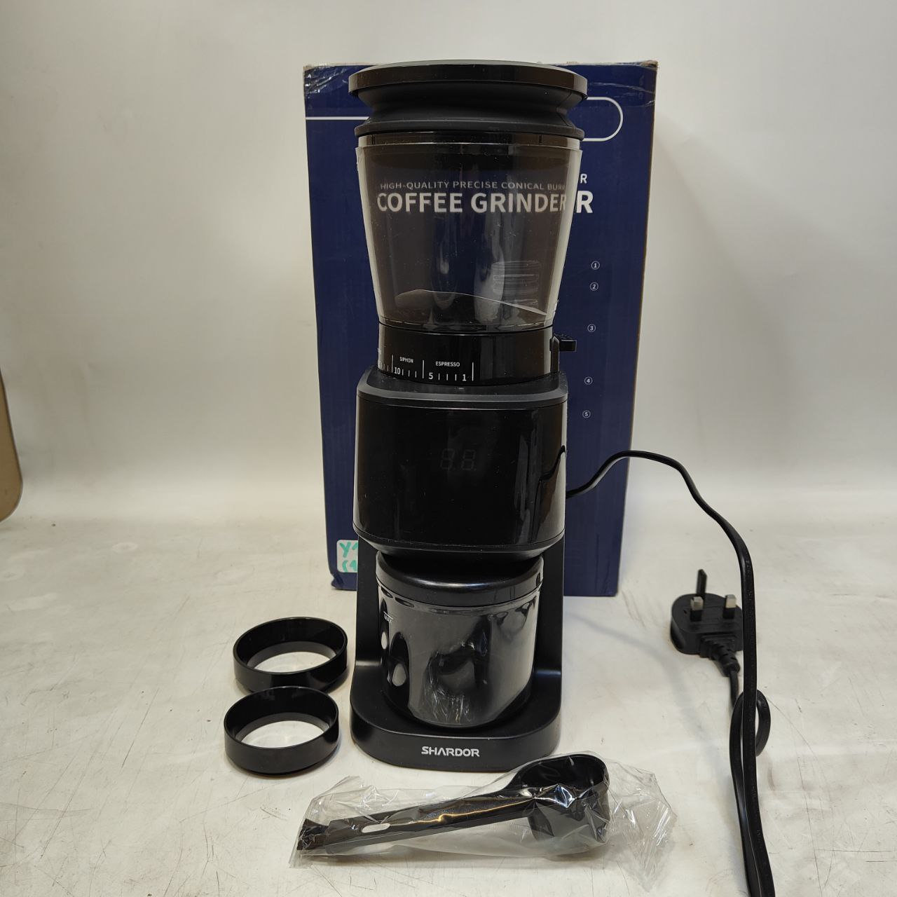 Coffee grinder with accessories on a white background