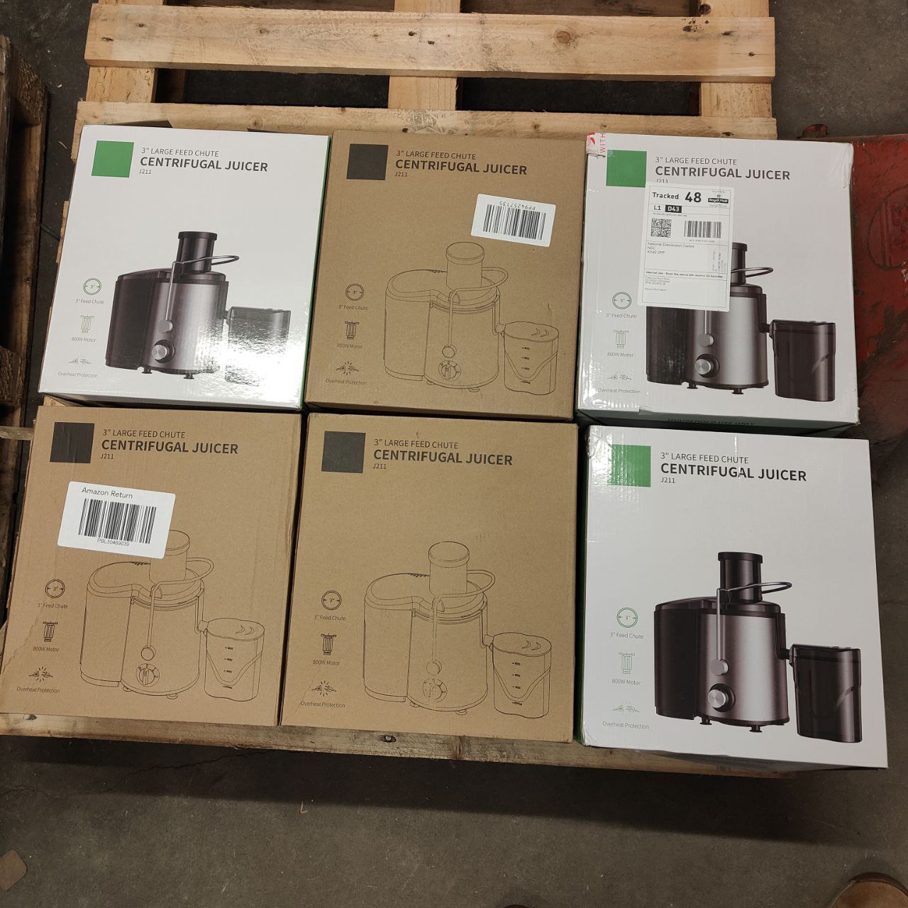 Multiple boxes of a centrifugal juicer on a wooden pallet.