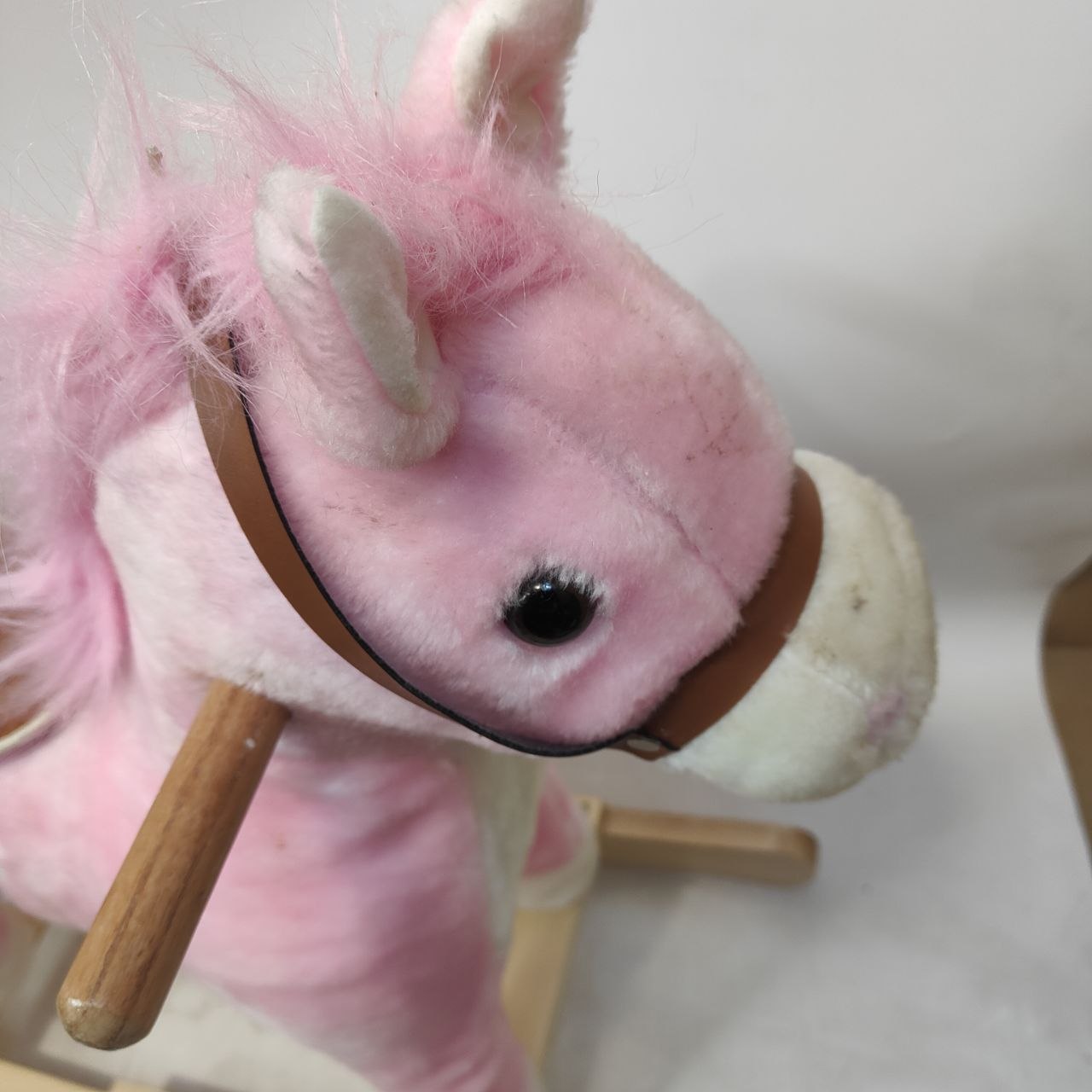 Close-up of a pink rocking horse with a blurred background