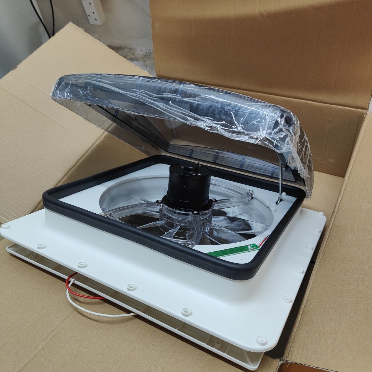 Ventilation fan on a cardboard box