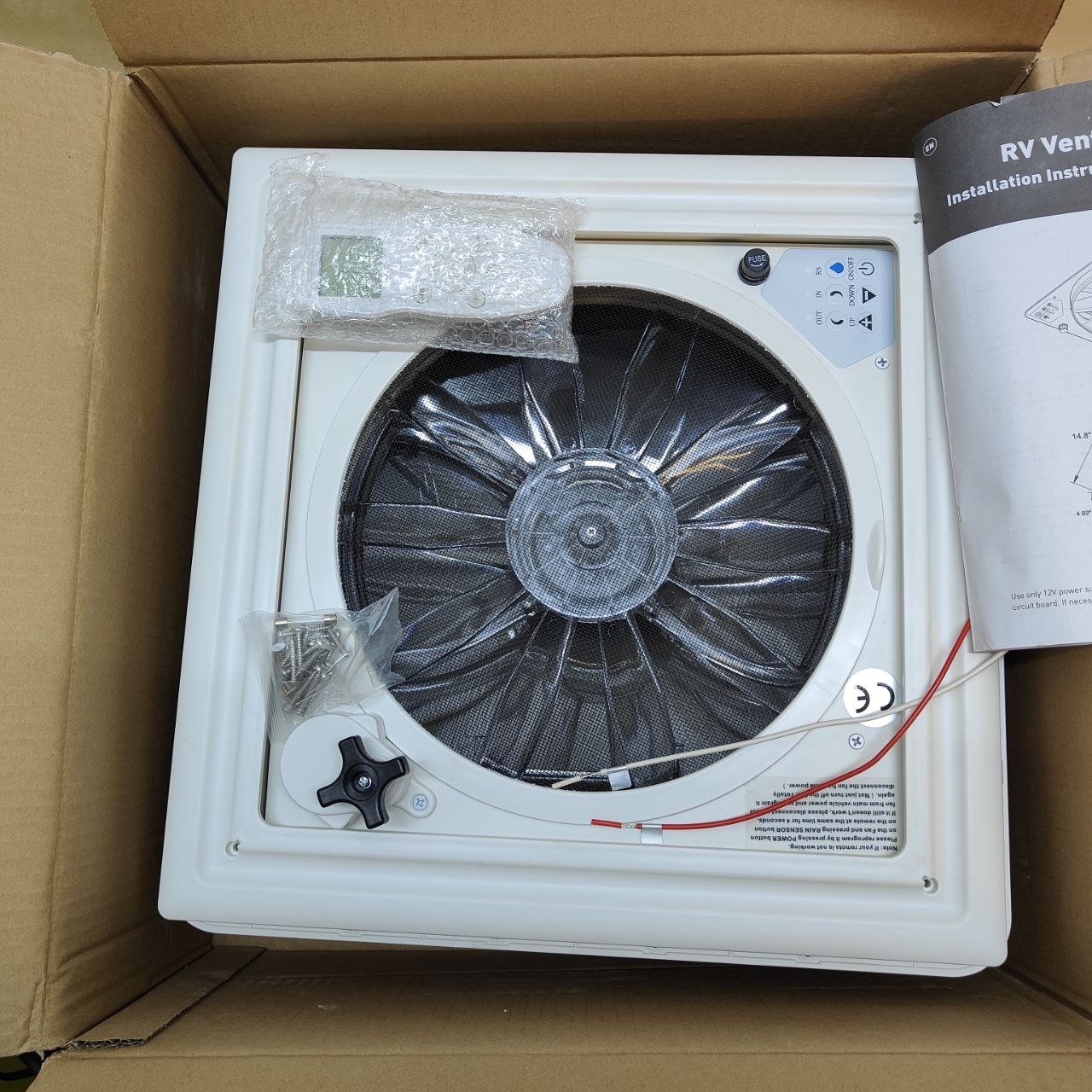 Ventilation unit in a cardboard box with installation instructions.
