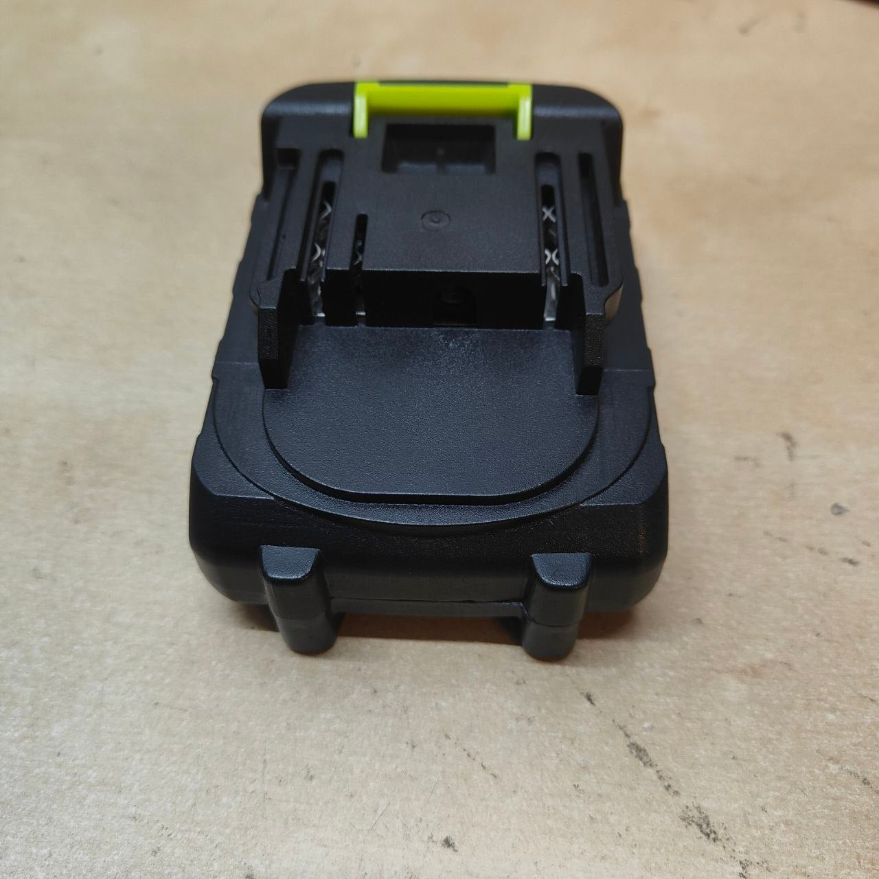 Black and yellow tool attachment on a beige surface
