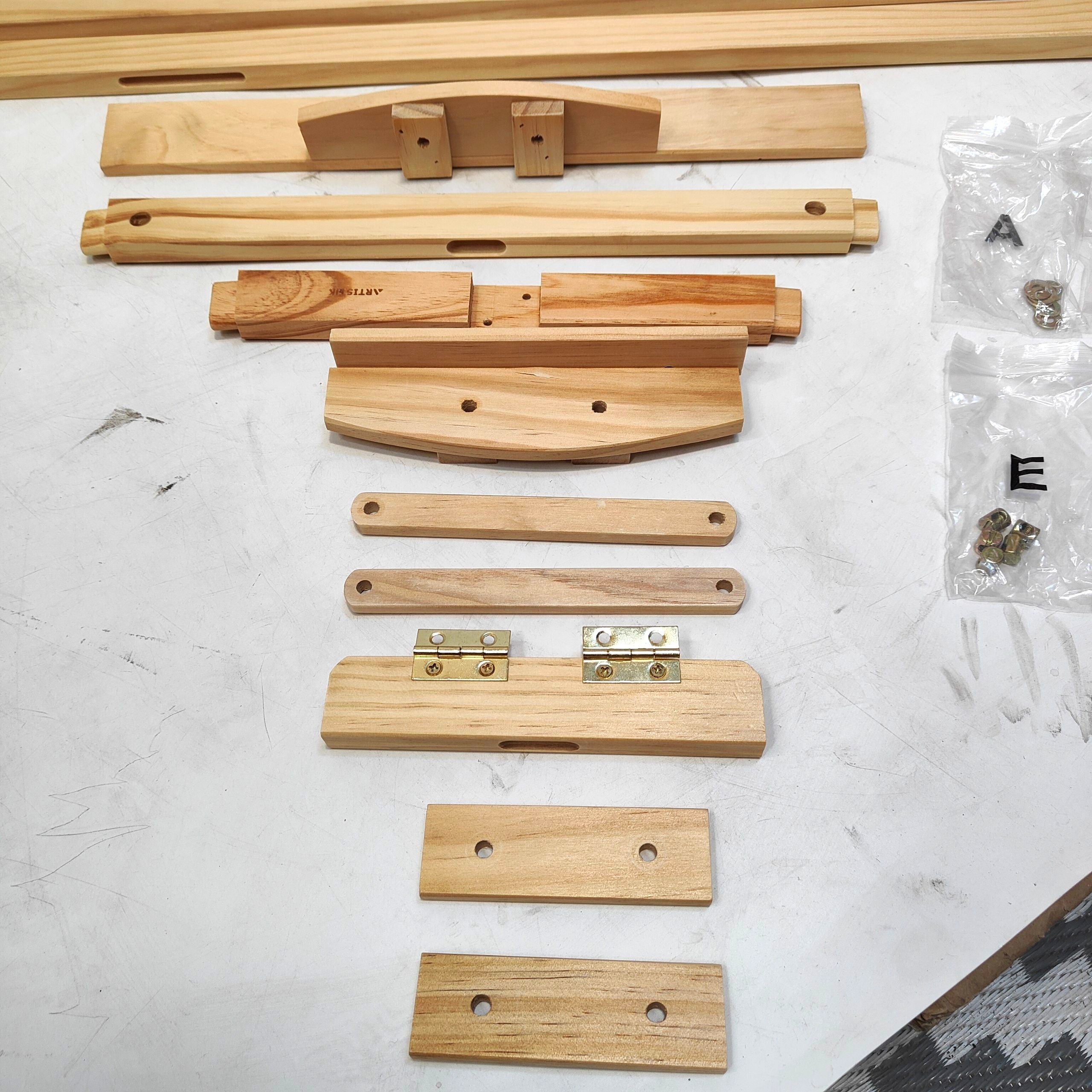 Wooden furniture assembly parts on a white surface with hardware.