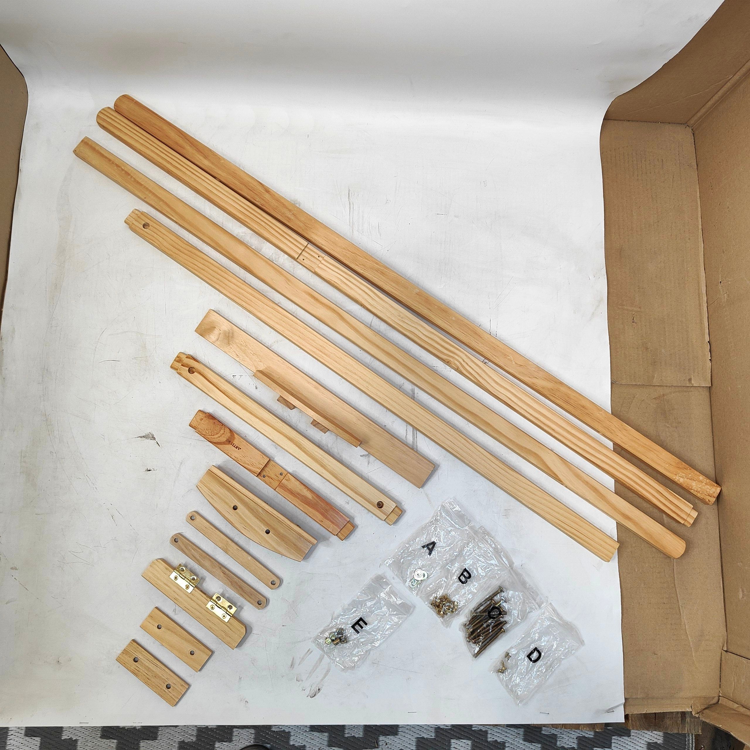 Wooden furniture assembly parts and hardware on a white surface