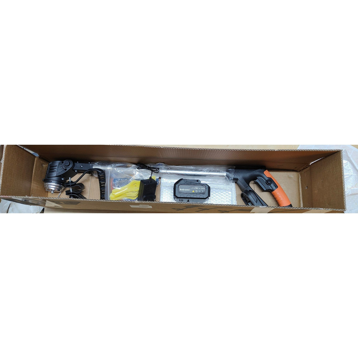 Tools and equipment inside a cardboard box on a white background