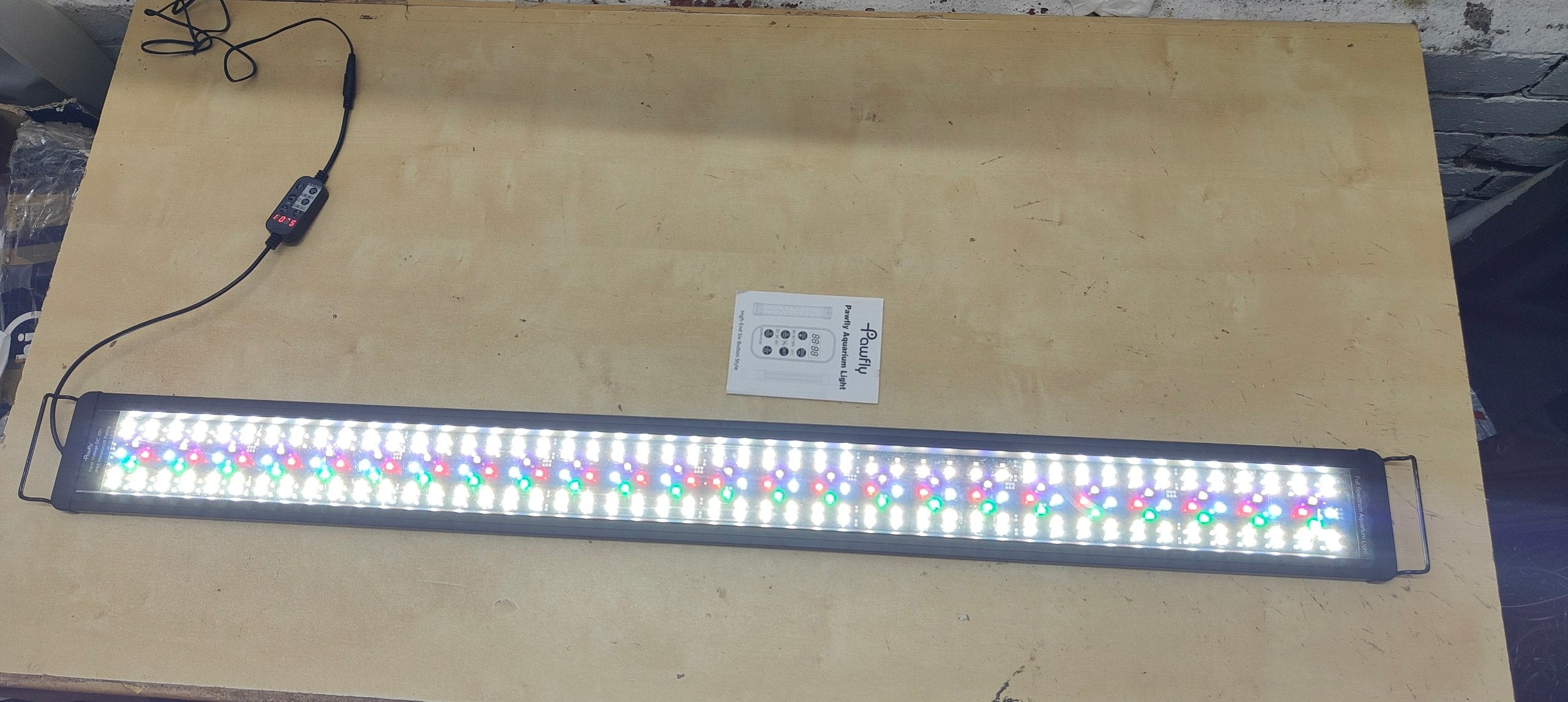LED light bar with control unit on a wooden surface