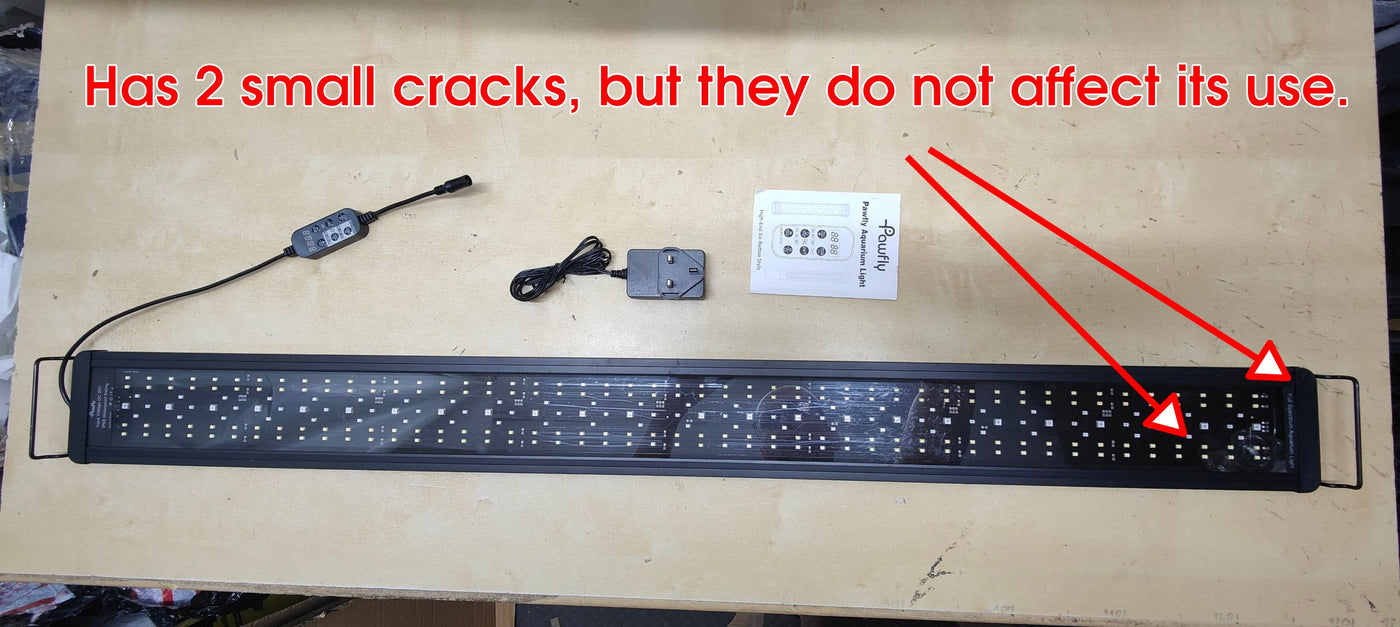 LED light strip with small cracks on a wooden surface, accompanied by a power adapter and user manual.