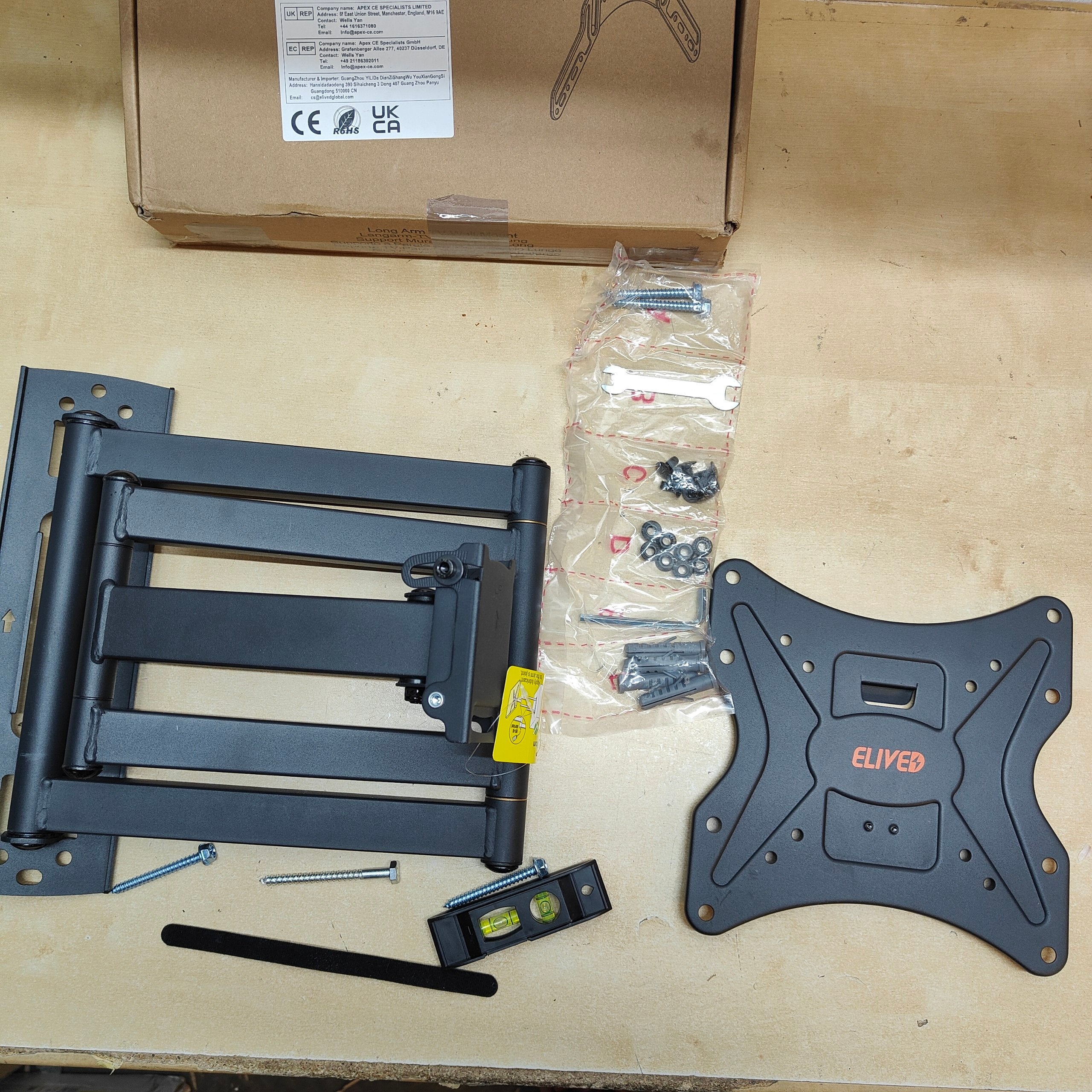 TV mount kit with components on a beige surface