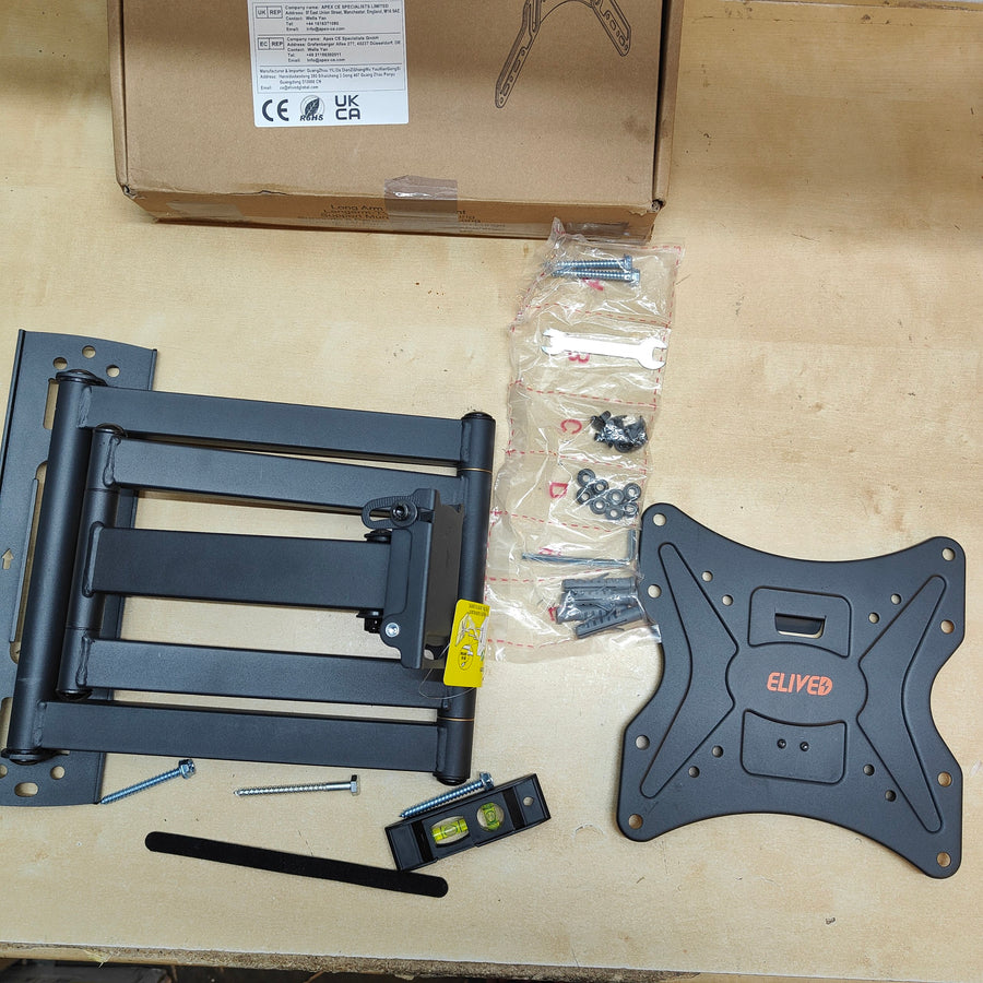 TV mount kit with components on a beige surface