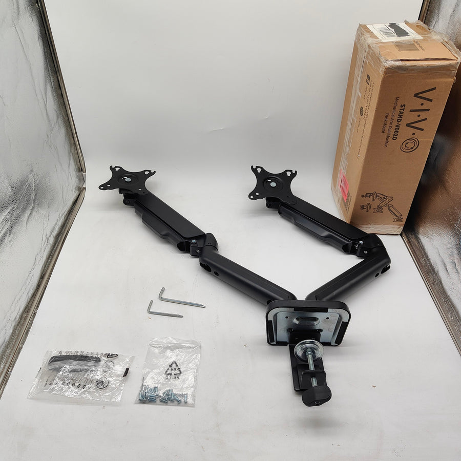 A black dual monitor arm mounting kit with two adjustable arms, two Allen wrenches, two small bags of hardware, and a brown VIV brand cardboard box on a white surface.