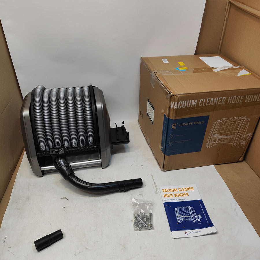 A vacuum cleaner hose windup with its black hose attached, shown alongside its cardboard packaging box, a small mounting hardware bag, and an instruction booklet on a white surface.