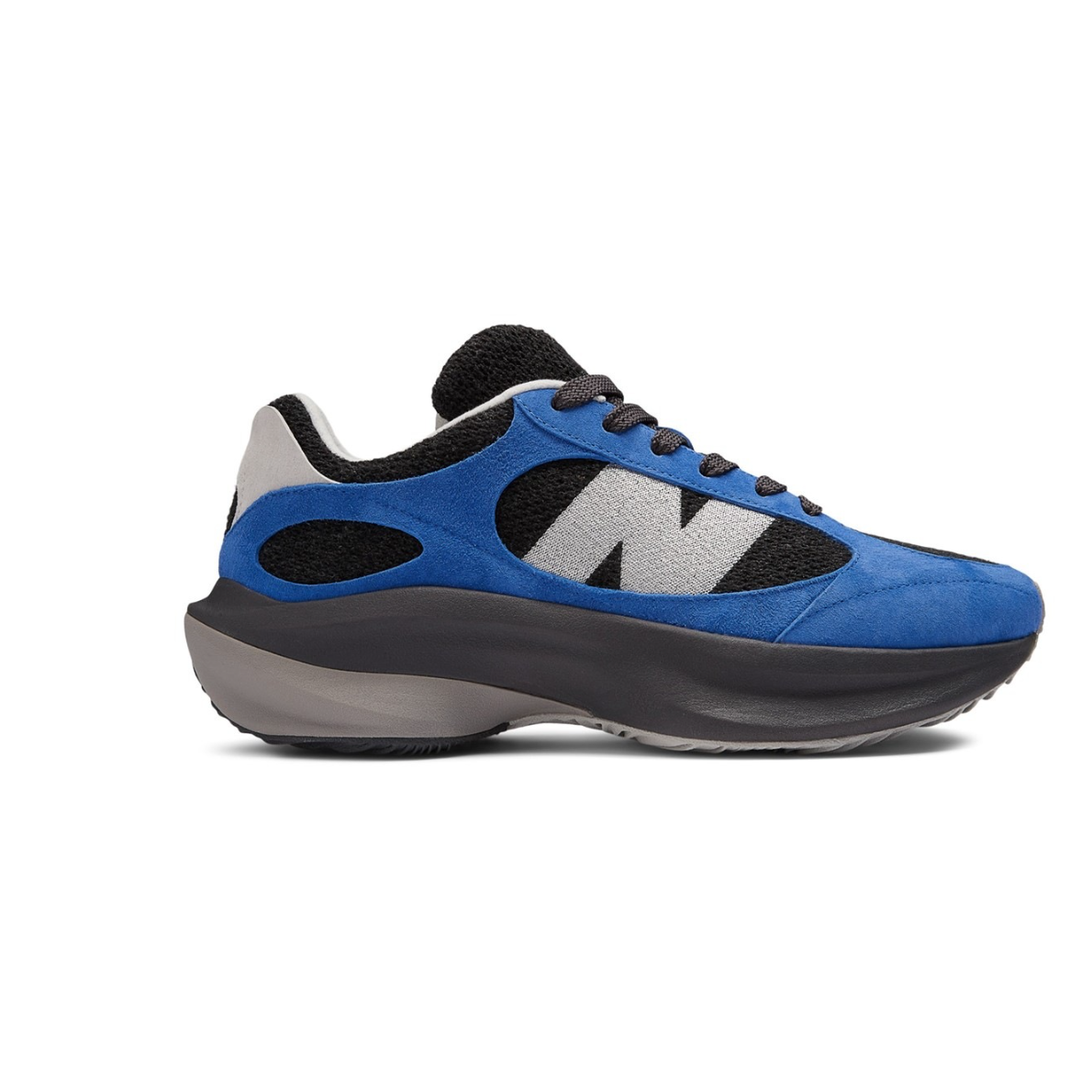 A pair of New Balance WRPD Runner sneakers in Marine Blue, featuring a black mesh base with blue suede overlays and an oversized grey 'N' logo.