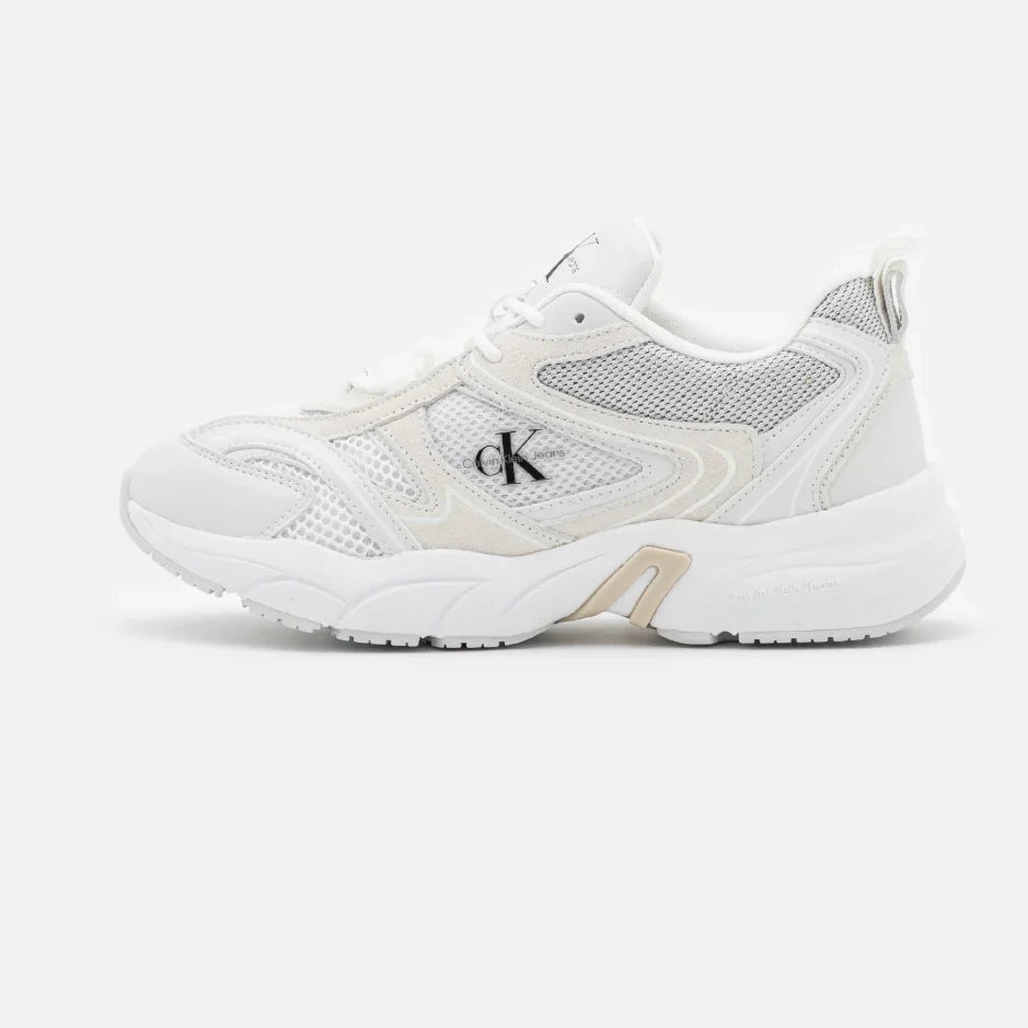 A pair of Calvin Klein Jeans retro tennis trainers, featuring a white suede and mesh material with a low-top design and flat rubber sole.