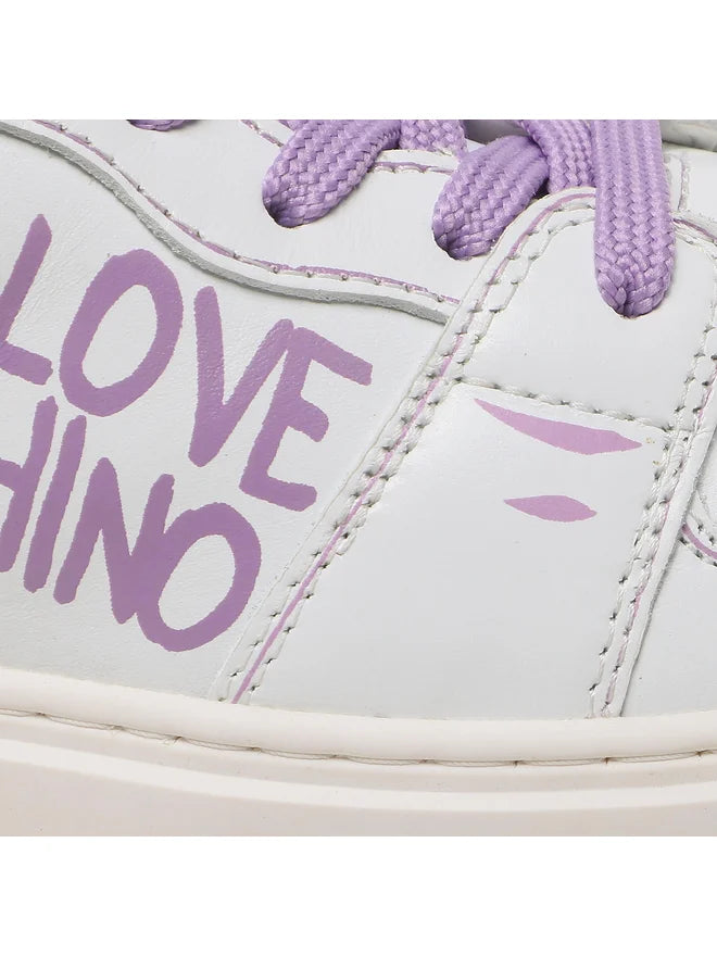 Close-up of a sneaker with 'LOVE CHINO' text on a white background