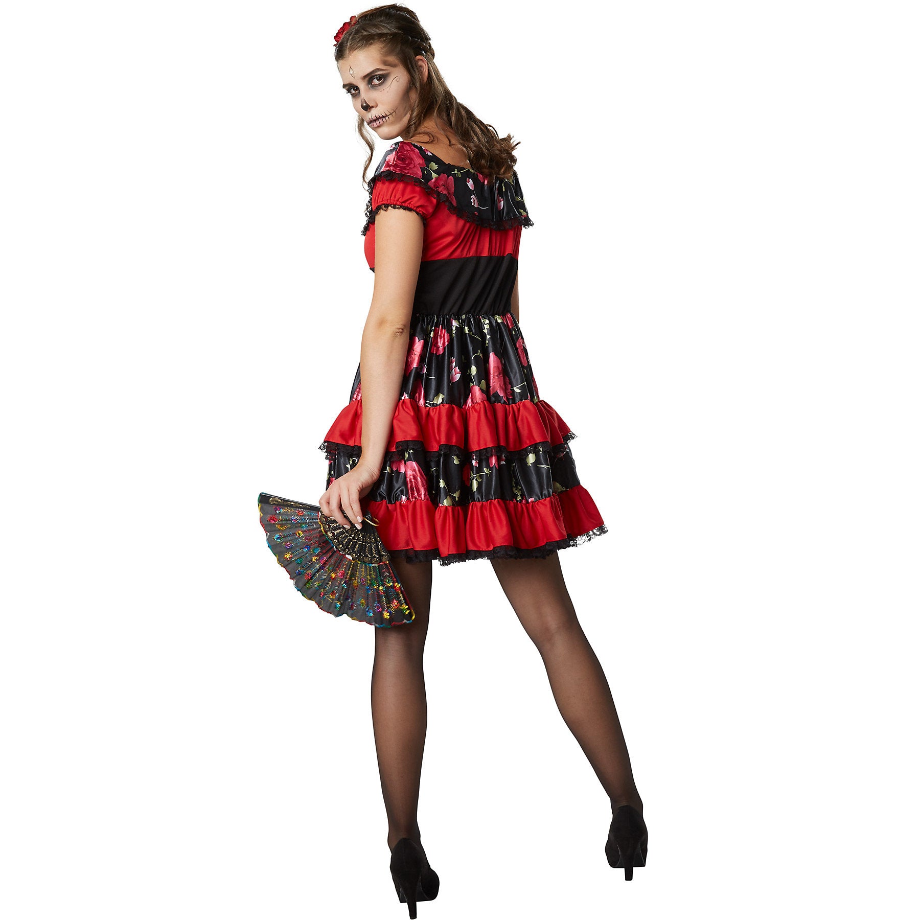 Woman wearing a red and black dress with ruffles on a white background