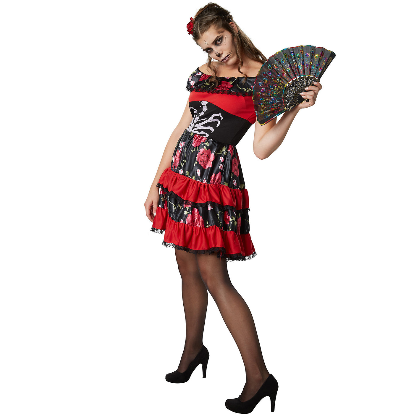 Woman wearing a colorful dress with floral patterns and a fan on a white background