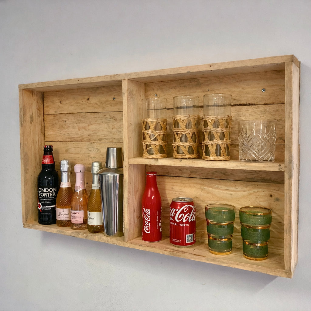 Wooden wall-mounted shelf with bottles, glasses, and a can on a gray background