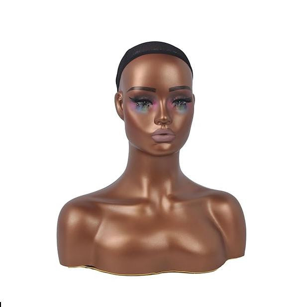 Mannequin head with dark hair bun on a white background